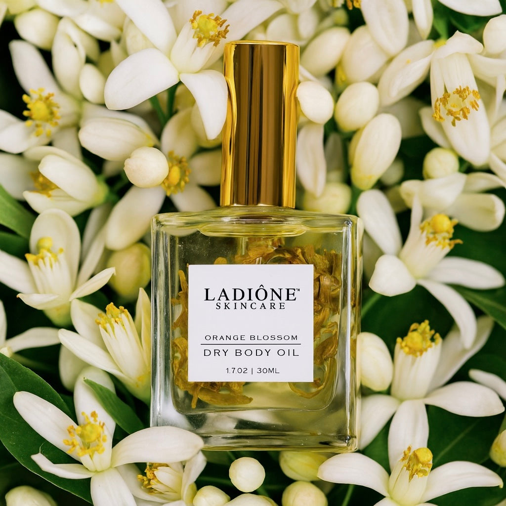 Ladiéne skincare orange blossom dry body oil bottle surrounded by white flowers